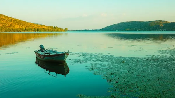 Small motorboat floating on a calm lake